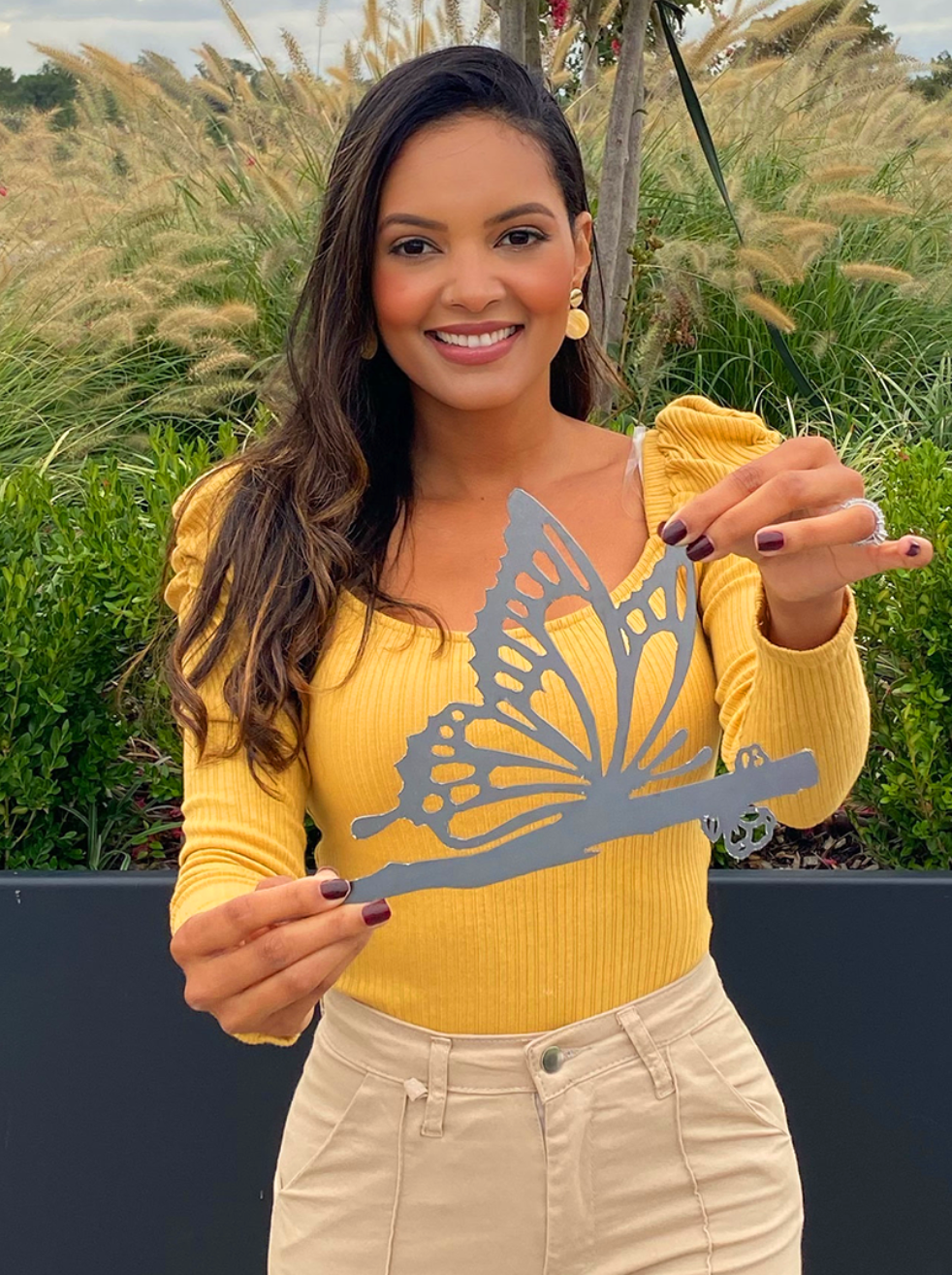 Customer holding a butterfly steel silhouette